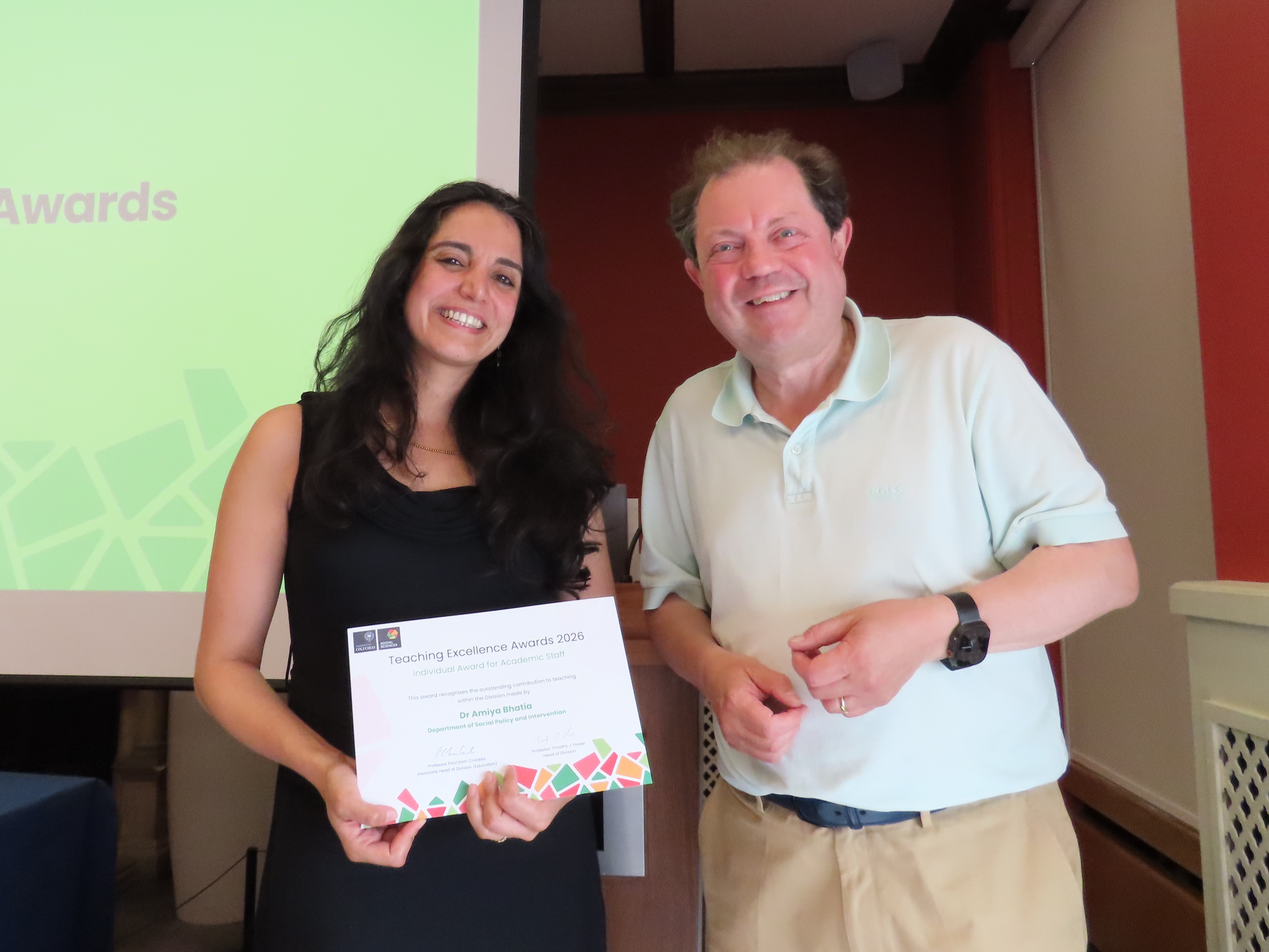 Dr Amiya Bhatia, wearing a black dress, stands next to Professor Paul Irwin-Crookes