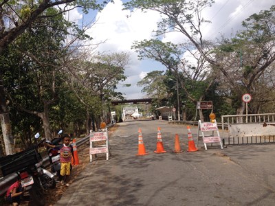 A closed road in Columbia, with a young boy standing at the side