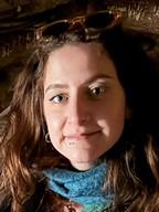Woman with long brown hair and blue scarf