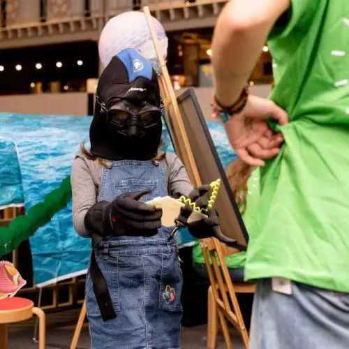 Child in diving outfit at workshop in the museum