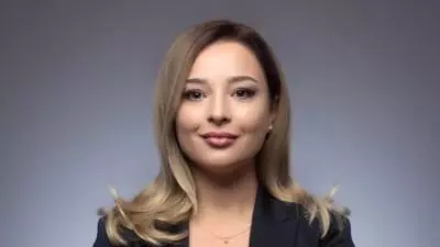 Tamta has light coloured long hair and is smiling into the camera