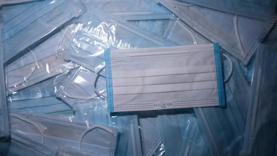 A pile of blue, medical grade face masks