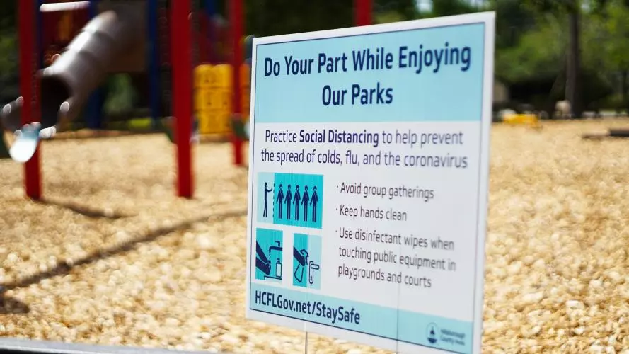 Government advice poster in front of an empty children's playground_jordan hopkins xxgpojrufbc unsplash