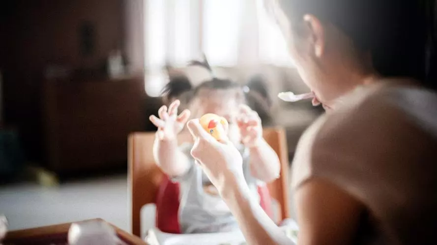 A mother feeds her child 