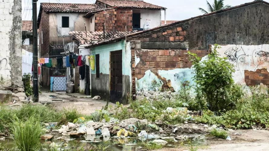 A dilapidated house with washing hanging outside