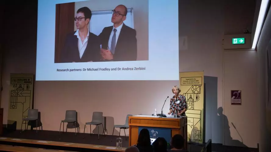 Presentation screen at the awards ceremony shows a photograph and special mention of Dr Michael Fradley and Dr Andrea Zerbini