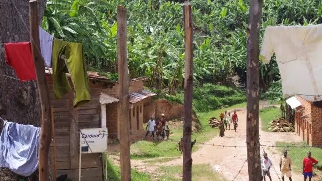 Village in Burundi with wooden houses, trees and washing hanging out