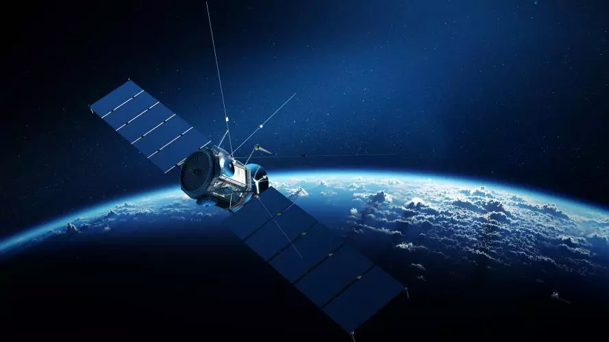 Communications satellite orbiting Earth with sunrise in space