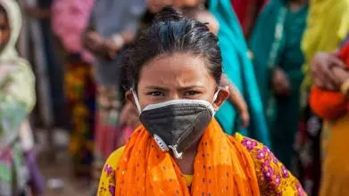 A young girl wearing a face mask