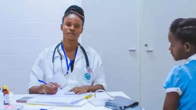 A female doctor in Angola treats a patient