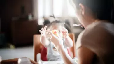 A mother feeds her child 