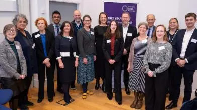 15 delegates from academia, policy, practice, business, and the third sector stand together