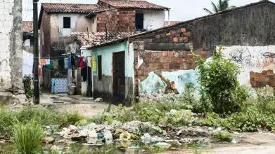 A dilapidated house with washing hanging outside