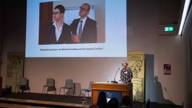 Presentation screen at the awards ceremony shows a photograph and special mention of Dr Michael Fradley and Dr Andrea Zerbini