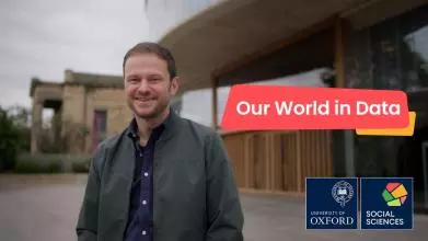 Prof Max Roser stands in front of the Blavatnik School of Government with the title 'Our World in Data'