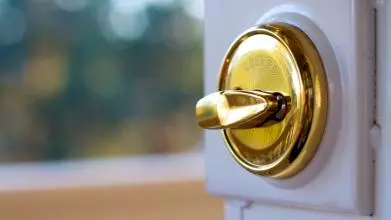 An unlocked door opens to reveal the world outside