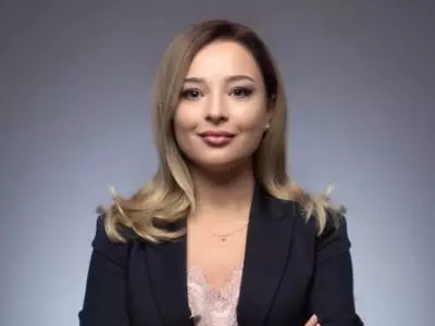 Tamta has light coloured long hair and is smiling into the camera