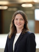 White woman with long brown hair in black jacket