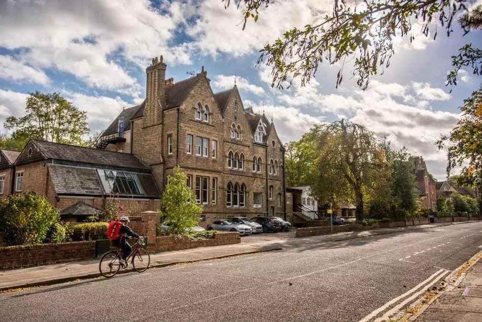 Photograph of the Education Department building with someone riding passed on a bike